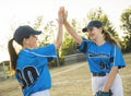 Group of baseball players standing together on the playground giving high five Royalty Free Stock Photo