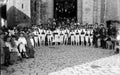 Group of Basque children dancing in front of a church