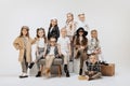 Group of beautiful kids, little girls and boys in modern outfits posing on grey studio background. Beauty, kids fashion Royalty Free Stock Photo