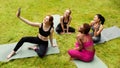 Group of beautiful sporty girls taking selfie before their yoga practice in nature Royalty Free Stock Photo