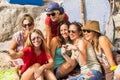 Group of beautiful young females friends having fun together outdoor in leisure activity doing a selfie with a smartphone.