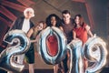 Group of beautiful young friends with inflatable numbers in hands celebrating new 2019 year Royalty Free Stock Photo