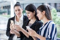 group of beautiful young women friends using a smart phone and laughing outdoors .three girl exciting business online of news Royalty Free Stock Photo
