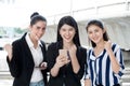 group of beautiful young women friends using a smart phone and laughing .three girl exciting business online of news Royalty Free Stock Photo