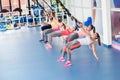 Group of beautiful young women working out on TRX Royalty Free Stock Photo