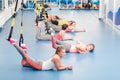 Group of beautiful young women working out on TRX. Resting time Royalty Free Stock Photo