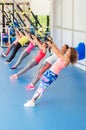 Group of beautiful young women working out on TRX. Royalty Free Stock Photo