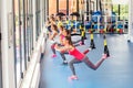 Group of beautiful young women working out on TRX. Royalty Free Stock Photo