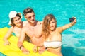 Group of best friends taking selfie at the swimming pool