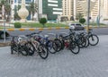 A group of bycicles parked in a parking space in abu dhabi street.a group of bicycles parked in a parking space in abu dhabi