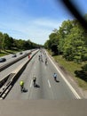 Group of bicyclists cycling down a highway on a sunny day