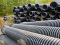 Group of big corrugated pipes made of black plastic