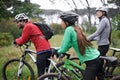 Group, bike and cycling outdoor with relax for exercise, workout or adventure in forest with fitness. Friends, people or