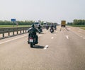 A group of bikers are driving along the highway