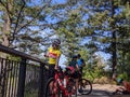 Group of bikers resting at the top of a hill at Snoqualmie Falls Park on a sunny day in the mountains Royalty Free Stock Photo