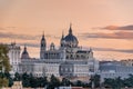 Group of birds flying over Madrid skyline at Sunset. Almudena cathedral and Royal Palace. Royalty Free Stock Photo