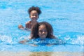 Group of black children happy playing water pool park outdoor in hot summer season Royalty Free Stock Photo