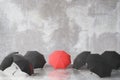 Group of black and one red umbrella Royalty Free Stock Photo