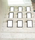 Group of black photo frames on rough concrete stair at building,