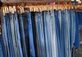 Group of Blue Denim Jeans Hanging on a Rack Royalty Free Stock Photo