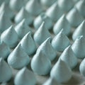 Group of blue meringues, close up shot. Airy meringue in form of drop, fresh from the oven. Delicate dessert, egg sweets