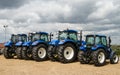 A group of blue tractors parked up Royalty Free Stock Photo