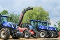A group of blue tractors parked up