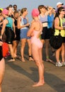 A group of body marked triathletes before a swim start