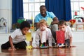 Group Of Boys Carrying Out Experiment In Science Class