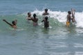 A group of boys enjoy a swim in the sea.