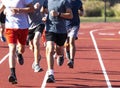 Group of boys run training on a track Royalty Free Stock Photo