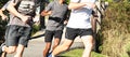 Group of boys running in a park turning to their left Royalty Free Stock Photo