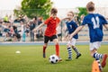 Group of boys in two kids soccer teams competing for the ball on a football tournament match. Soccer school children playing game Royalty Free Stock Photo