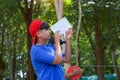 Group of boys using clinometer Measure the height of trees to calculate the trees' carbon storage. Royalty Free Stock Photo