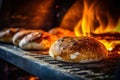 A group of breads sitting in an oven with a fire in the background, created by Generative AI Royalty Free Stock Photo