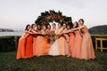 Group of bridesmaids standing in an outdoor field in Victoria, wearing colorful dresses