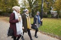 Group Of British Muslim Women Friends Walking Through Park