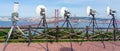 group of broadcast satellite dishes towards Lisbon and 25 de Abril bridge mounted next to the statue of Christ the King of Almada