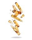 Group of broken ampoules of yellow color in the air on a white background
