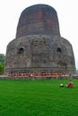 Group of Buddhist monks perform religious activity at Dhamekh Stupa, the place for first Buddha Royalty Free Stock Photo