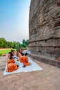 Group of Buddhist monks perform religious activity at Dhamekh Stupa, the place for first Buddha Royalty Free Stock Photo