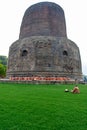 Group of Buddhist monks perform religious activity at Dhamekh Stupa, the place for first Buddha Royalty Free Stock Photo