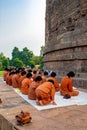 Group of Buddhist monks perform religious activity at Dhamekh Stupa, Royalty Free Stock Photo