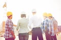 Group of builders and architects at building site Royalty Free Stock Photo