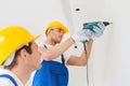 Group of builders with drill indoors Royalty Free Stock Photo