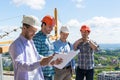 Group Of Builders In Hardhats Meeting On Construction Site Building Team Working With Plan Engineer Teamwork