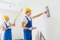 Group of builders with tools indoors Royalty Free Stock Photo