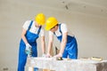 Group of builders with tools indoors Royalty Free Stock Photo