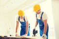 Group of builders with tools indoors Royalty Free Stock Photo