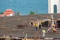 Group of building workers in hard hats working on construction site near the blac sea coast Royalty Free Stock Photo